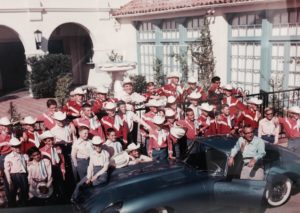 Group photo of choristers and Eduardo Caso with his car